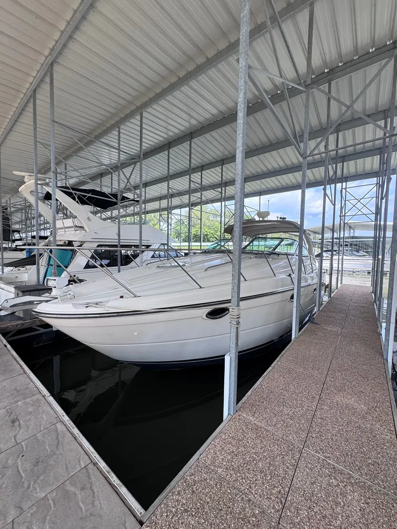 Slide: The Image of A 2001 Maxum 3500 SCR is docked in a covered marina. - 1