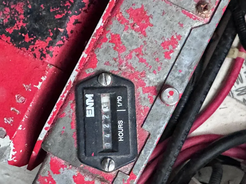 Slide: The Image of Close-up of an hour meter with worn red paint and cables. - 23