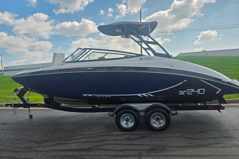 Slide: The Image of 2016 Yamaha AR240 boat on trailer, parked outdoors under a cloudy sky. - 4