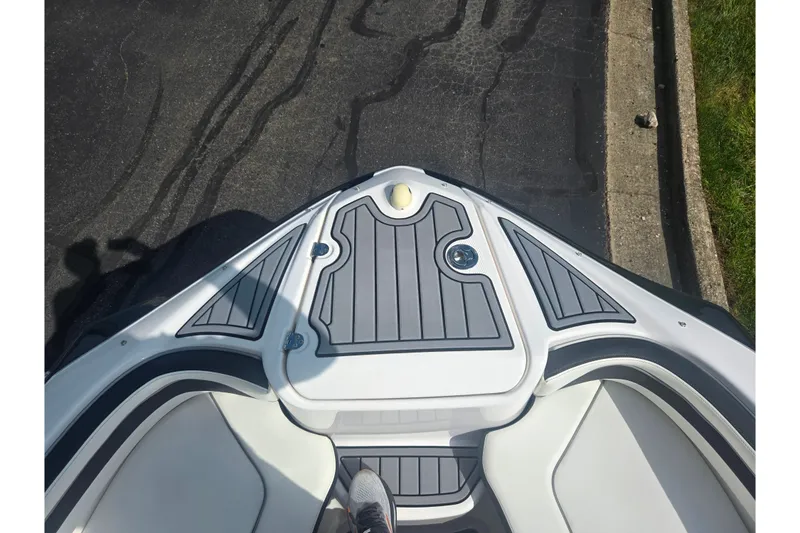 Slide: The Image of Bow view of 2016 Yamaha AR240 boat with sleek gray and white design. - 19