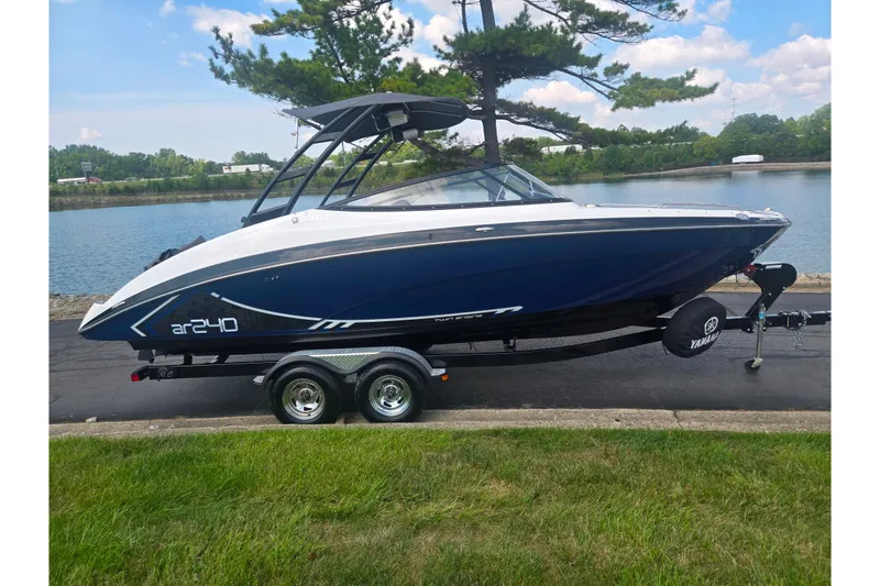 Slide: The Image of 2016 Yamaha Boats AR240 on trailer by a scenic waterfront. - 9