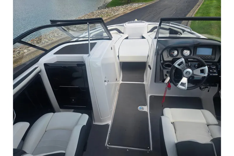 Slide: The Image of 2016 Yamaha Boats AR240 interior with steering wheel, dashboard, and seating. - 12