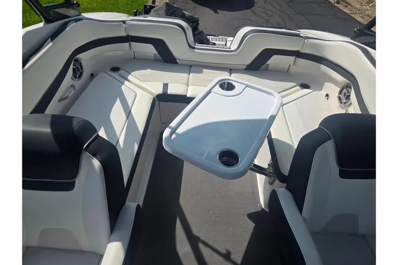 Slide: The Image of Interior of 2016 Yamaha AR240 boat with seating and table setup. - 23