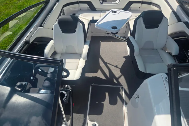 Slide: The Image of Interior of 2016 Yamaha AR240 boat with seating and table setup. - 22