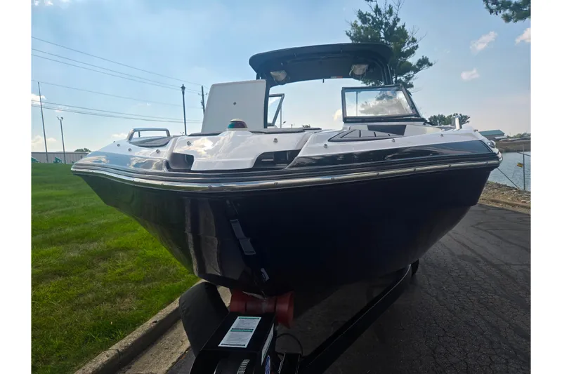 Slide: The Image of 2016 Yamaha Boats AR240 on trailer, parked near water, under clear blue sky. - 6