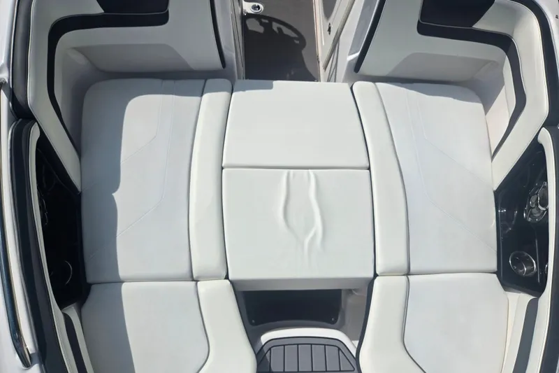 Slide: The Image of 2016 Yamaha Boats AR240 interior seating, featuring sleek white upholstery and modern design. - 20