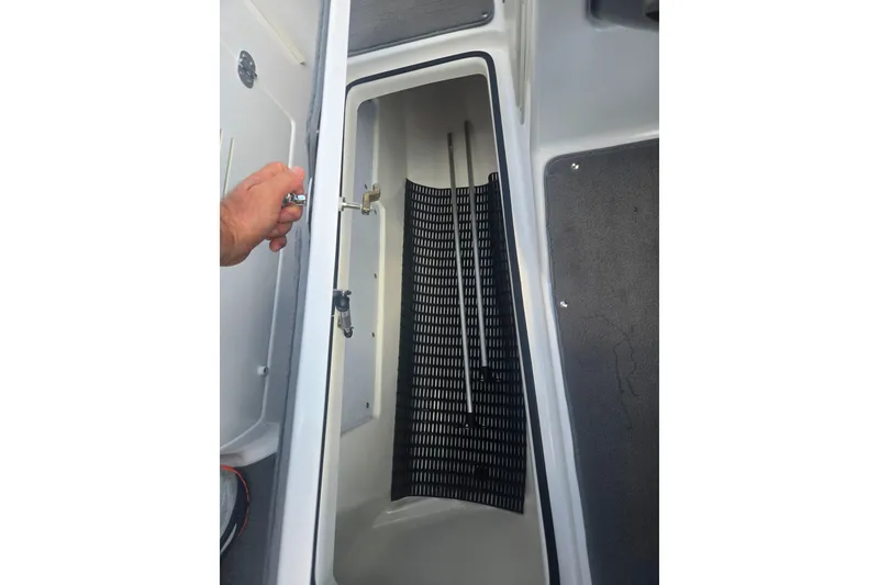 Slide: The Image of Open storage compartment on a 2016 Yamaha Boats AR240, showing interior details. - 14