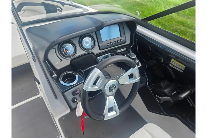 Slide: The Image of 2016 Yamaha Boats AR240 dashboard with steering wheel and control panel. - 13