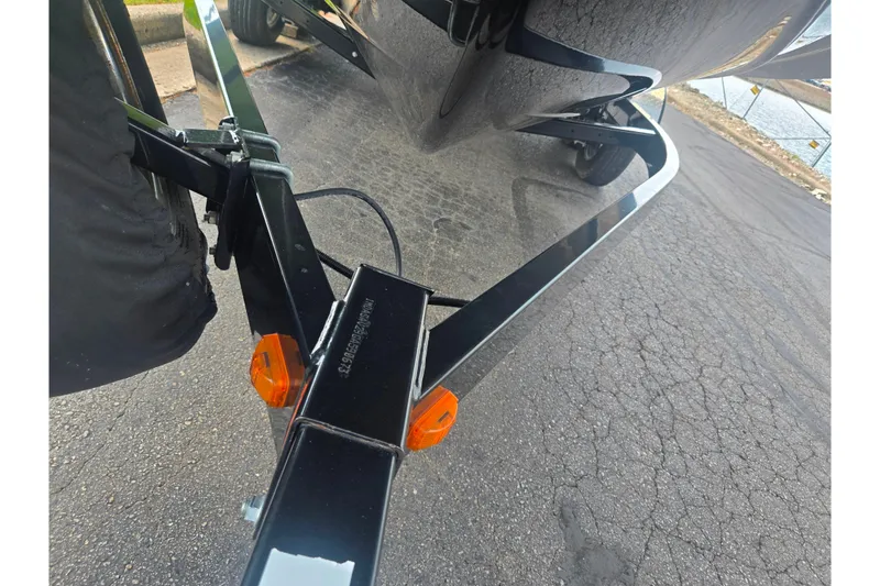 Slide: The Image of Trailer hitch of a 2016 Yamaha Boats AR240 on a paved road. - 7