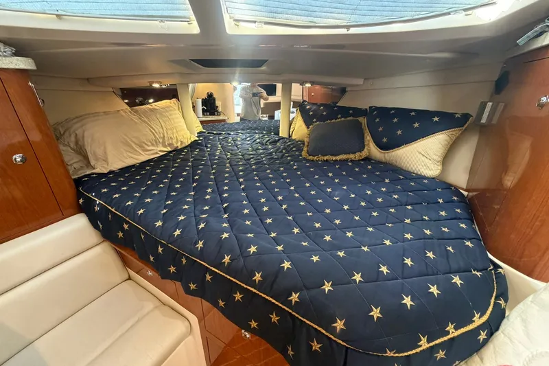 Slide: The Image of Luxurious cabin interior of 2006 Regal 3360 Window Express with star-patterned bedding. - 28