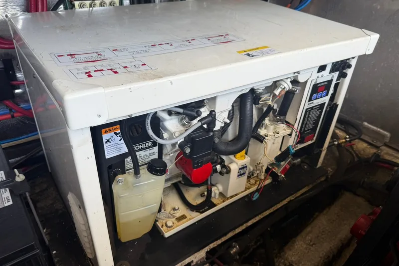 Slide: The Image of Engine compartment of a 2006 Regal 3360 Window Express boat, featuring a Kohler generator. - 42