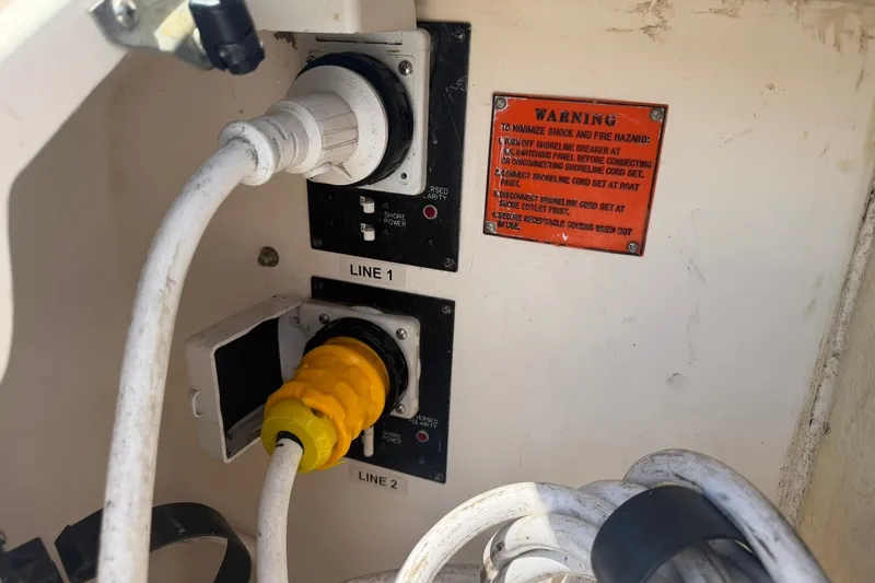 Slide: The Image of Power connections on a 2006 Regal 3360 Window Express boat with warning label. - 38