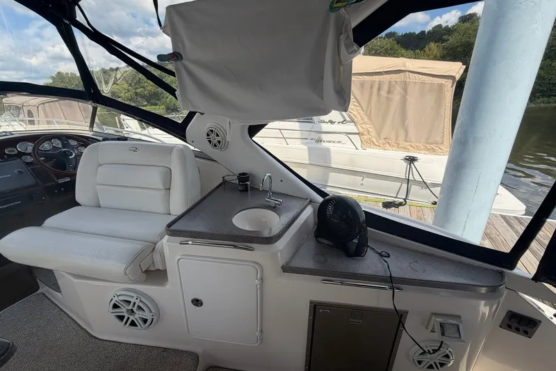 Slide: The Image of Interior of a 2006 Regal 3360 Window Express boat with seating and sink area. - 15