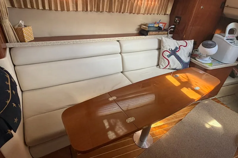 Slide: The Image of Interior of a 2006 Regal 3360 Window Express yacht with a cozy seating area. - 30