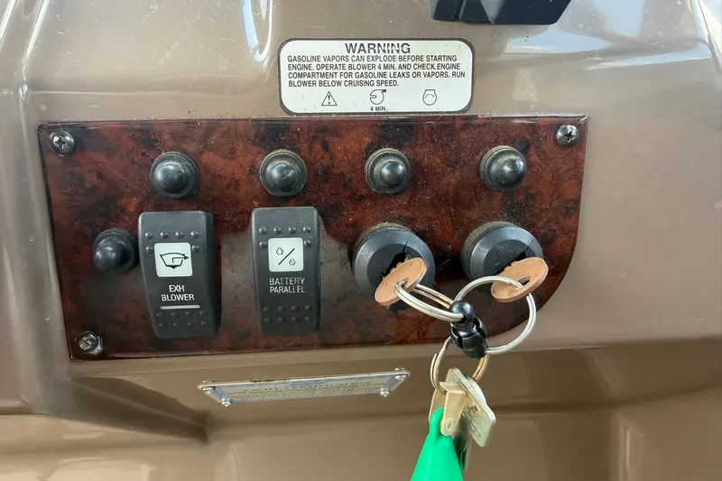 Slide: The Image of Control panel of a 2006 Regal 3360 Window Express boat with keys and switches. - 22
