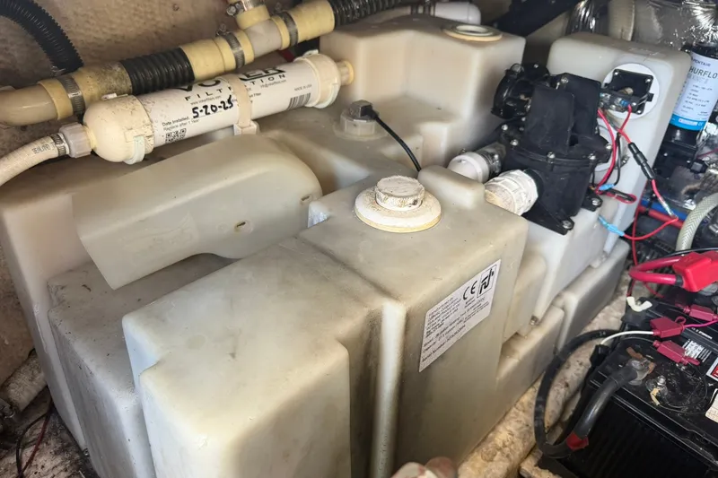 Slide: The Image of Engine compartment of a 2006 Regal 3360 Window Express boat, showing water tanks and filtration system. - 41