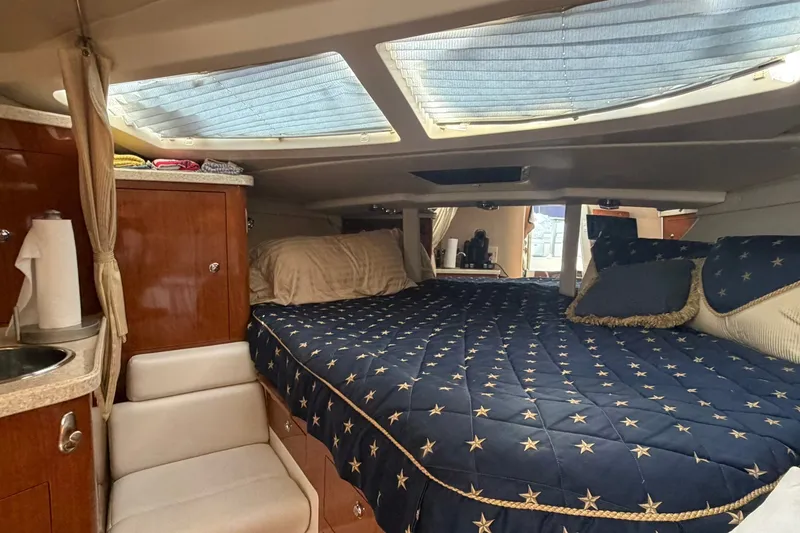 Slide: The Image of Interior cabin of 2006 Regal 3360 Window Express with cozy bedding and wooden cabinetry. - 25