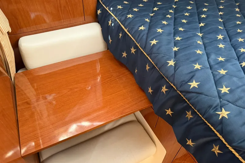 Slide: The Image of Interior of 2006 Regal 3360 Window Express with star-patterned bedding and wooden table. - 36