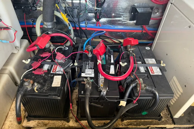 Slide: The Image of Batteries and wiring in a 2006 Regal 3360 Window Express boat engine compartment. - 40