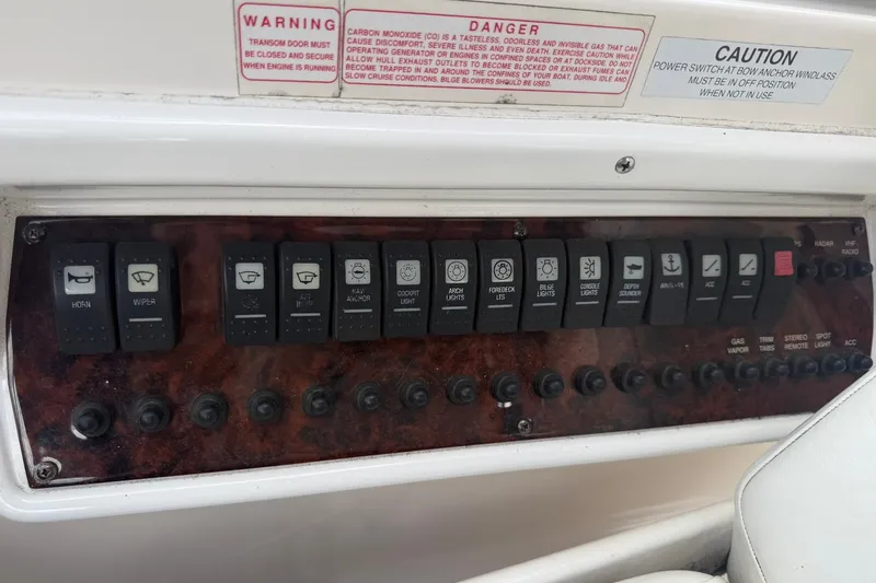 Slide: The Image of Control panel of a 2006 Regal 3360 Window Express boat with labeled switches and warnings. - 21