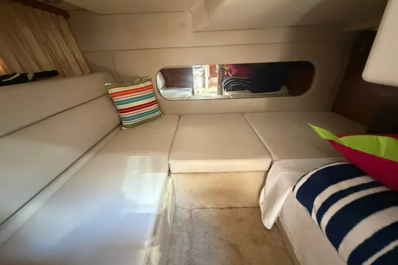 Slide: The Image of Interior of 2006 Regal 3360 Window Express with cozy seating and colorful pillows. - 26