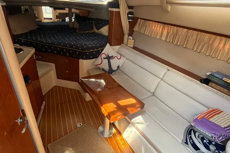 Slide: The Image of Interior of 2006 Regal 3360 Window Express yacht with cozy seating and wooden accents. - 23