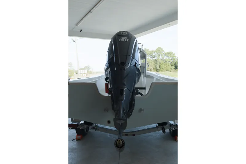 Slide: The Image of 2026 C-Hawk 20 Center Console boat with powerful outboard motor in a garage setting. - 4
