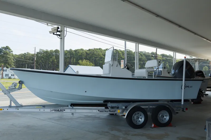 The Image of 2026 C-Hawk 20 Center Console boat on trailer under shelter. - 1
