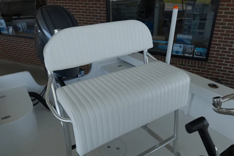 Slide: The Image of White cushioned seat on 2026 C-Hawk 20 Center Console boat, with motor in background. - 9