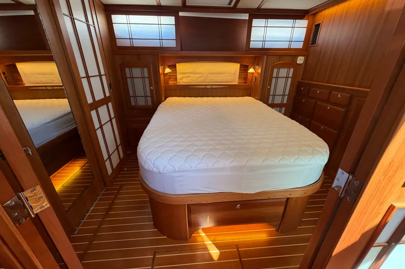 Slide: The Image of Luxurious 2018 Sabre 48 Salon Express cabin with elegant wood interior and cozy bed. - 13