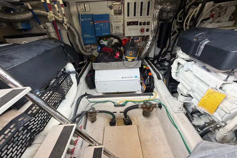 Slide: The Image of Engine room of 2018 Sabre 48 Salon Express with visible machinery and control panels. - 31
