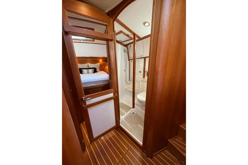 Slide: The Image of Interior of 2018 Sabre 48 Salon Express yacht, featuring a cozy bedroom and bathroom. - 19