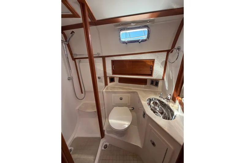 Slide: The Image of Luxurious bathroom in 2018 Sabre 48 Salon Express yacht with modern fixtures and wood accents. - 20