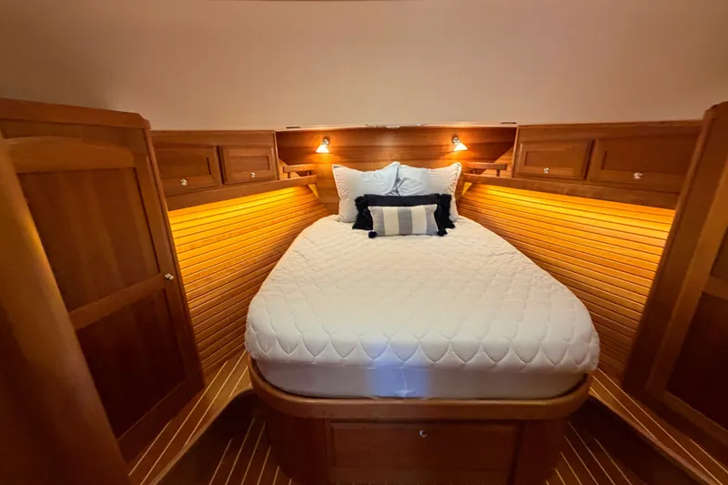 Slide: The Image of Luxurious cabin interior of 2018 Sabre 48 Salon Express yacht with cozy bed and warm lighting. - 17