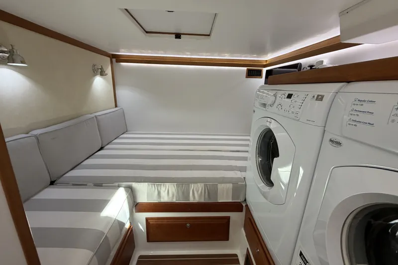 Slide: The Image of Laundry area with striped seating in 2018 Sabre 48 Salon Express yacht interior. - 23