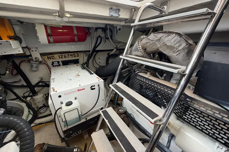 Slide: The Image of Engine room of 2018 Sabre 48 Salon Express with Cummins Onan generator and ladder. - 30