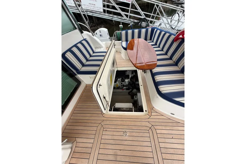 Slide: The Image of 2018 Sabre 48 Salon Express yacht with open engine hatch and striped seating. - 28