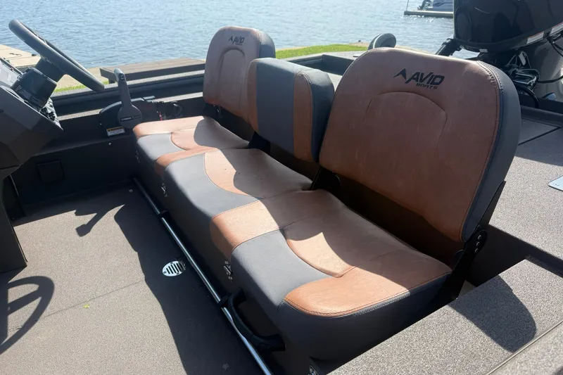 Slide: The Image of Interior seating of 2027 Avid 18 Rogue SC boat, featuring brown and gray upholstery. - 10