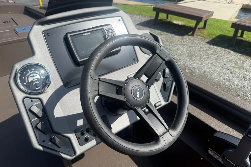 Slide: The Image of Steering wheel and dashboard of 2027 Avid 18 Rogue SC boat with Garmin display. - 11
