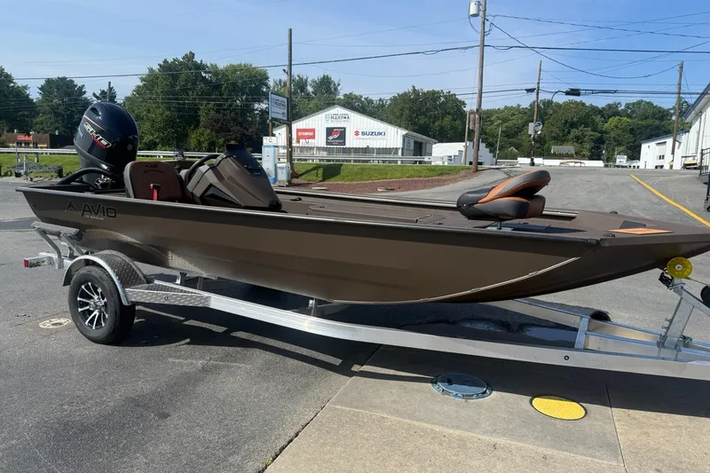 Slide: The Image of Avid 18 Rogue SC 2027 boat on trailer, parked outdoors on a sunny day. - 2