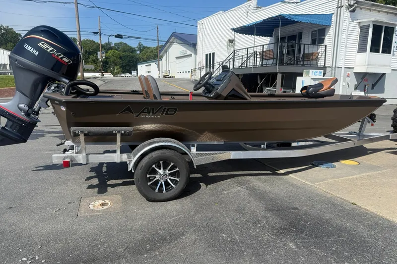 The Image of 2027 Avid 18 Rogue SC boat on trailer with Yamaha motor, parked outdoors. - 1