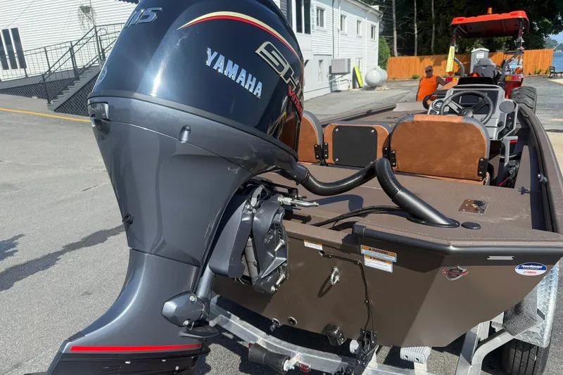 Slide: The Image of Avid 18 Rogue SC 2027 boat with Yamaha outboard motor in a parking area. - 6