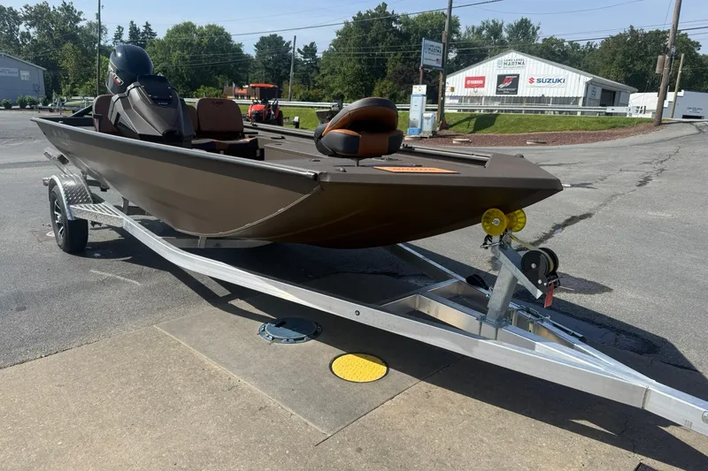 Slide: The Image of 2027 Avid 18 Rogue SC boat on trailer, parked outdoors near dealership. - 3