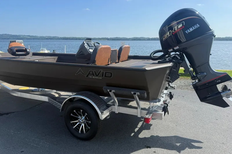 Slide: The Image of Avid 18 Rogue SC 2027 boat with Yamaha motor on trailer by lake. - 8