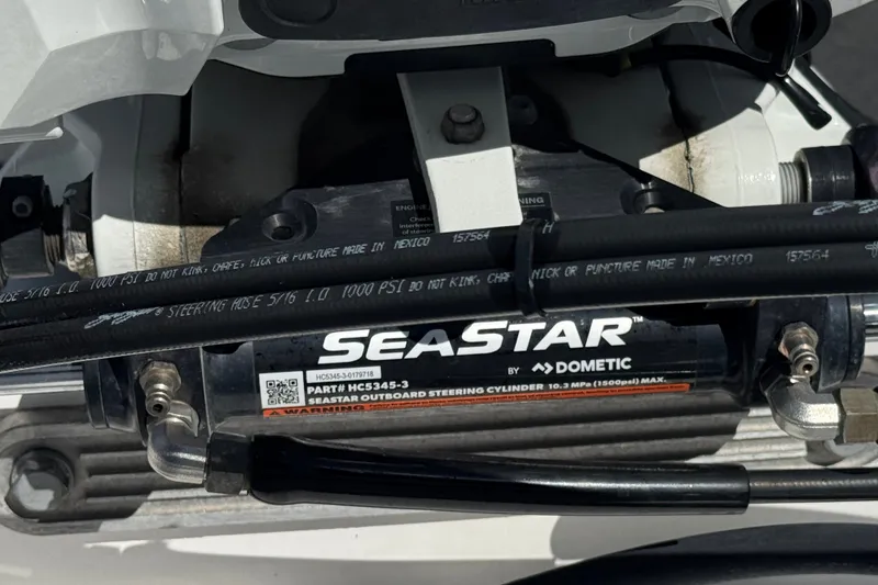 Slide: The Image of Close-up of SeaStar steering cylinder on 2024 NauticStar 211 Hybrid boat. - 26