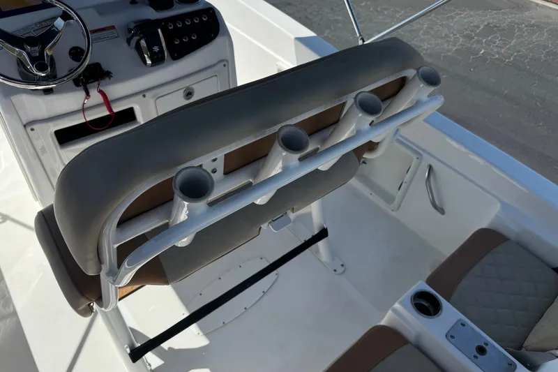 Slide: The Image of 2024 NauticStar 211 Hybrid boat interior with rod holders and steering console. - 31