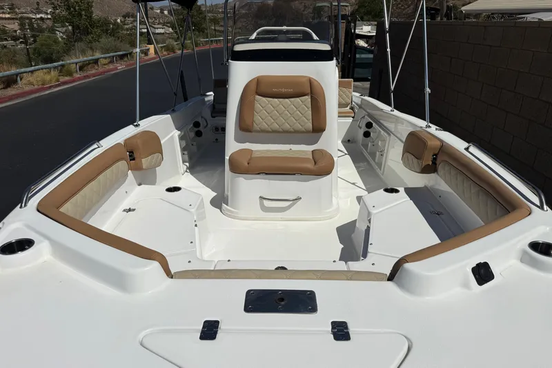 Slide: The Image of 2024 NauticStar 211 Hybrid boat interior with tan seating and white deck. - 11