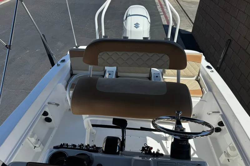 Slide: The Image of 2024 NauticStar 211 Hybrid boat interior with steering wheel and seating. - 19