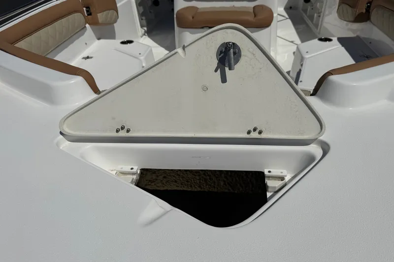 Slide: The Image of 2024 NauticStar 211 Hybrid boat interior with open storage compartment. - 10