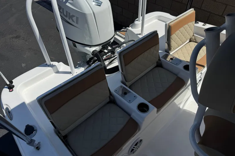 Slide: The Image of 2024 NauticStar 211 Hybrid boat interior with cushioned seating and Suzuki engine. - 20